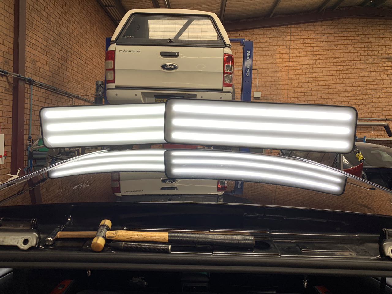 After photo showing the dark vehicle roof panel after Dent X PDR