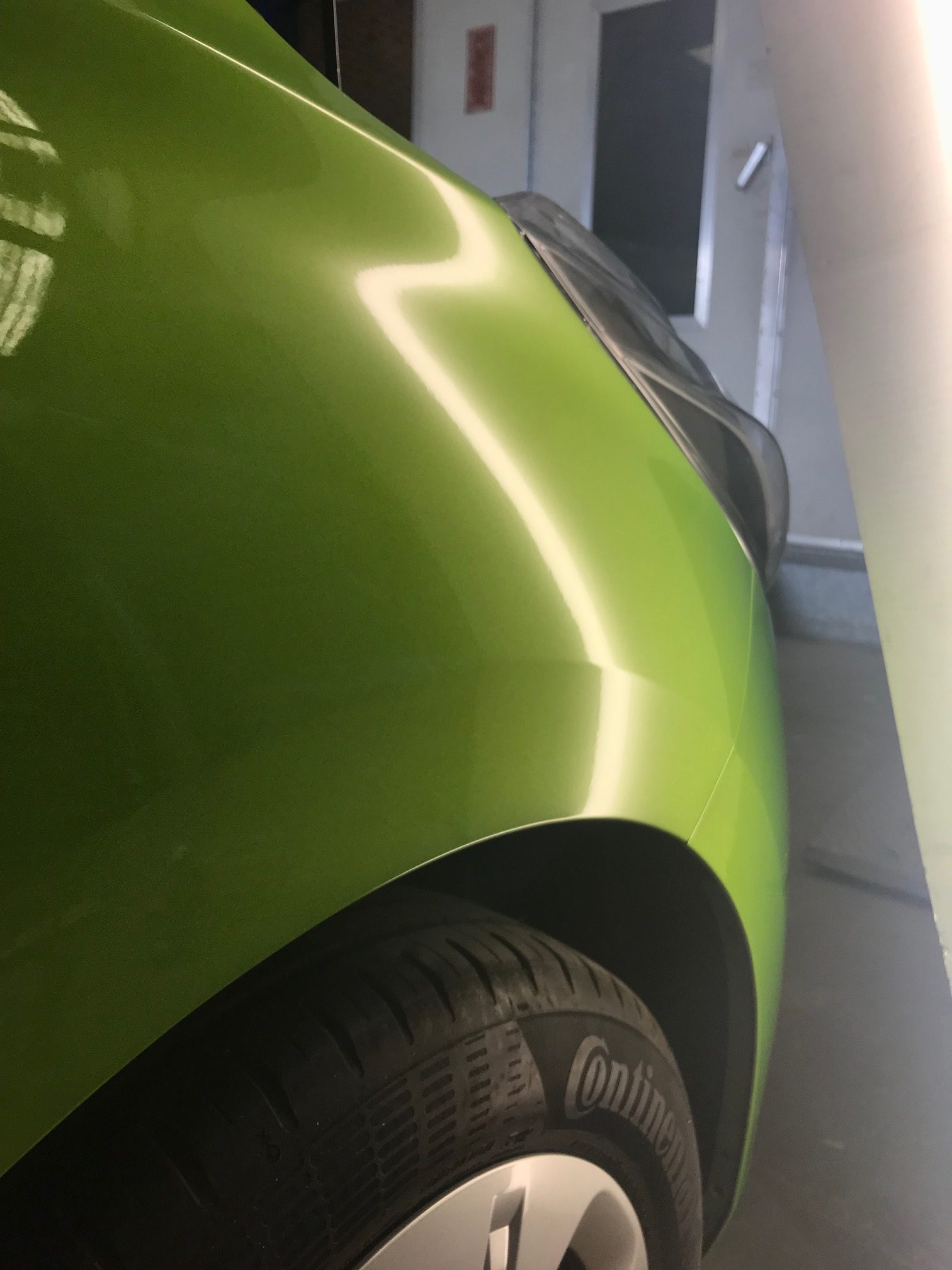 Dent X after photo showing the green front guard after paintless dent repair